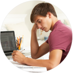 image of teenage boy studying or completing homework