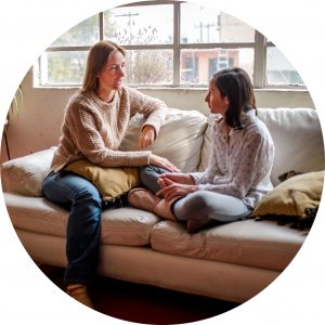 Students do well if they can - image of a girl talking to her mother on a couch - organising students