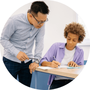 Organising Students BLOG - image of a student in a class room and asking a teacher for help 