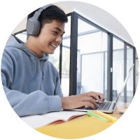 More than motivation: creating momentum in student learning - organising students - image of a boy smiling whilst he is on his computer studying